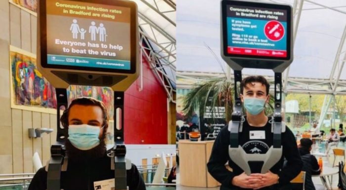 UK Gov’t Hires Men To Stand In Public With TV On Head For Pandemic Propaganda